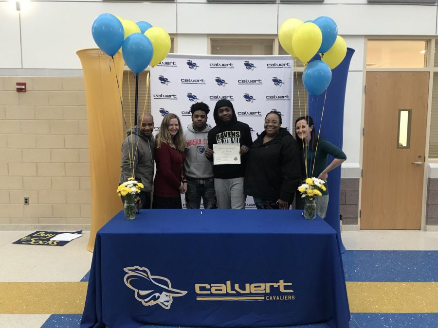 Aaron McCready holds certificate from AP Signings, surrounded by his family, along with English Teacher, Dr. Palmer and Vice Principal, Mrs. Sutton.