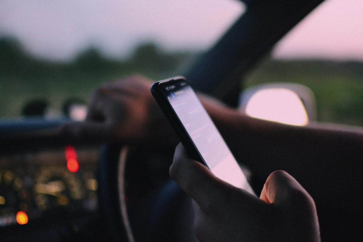 https://www.pexels.com/photo/a-person-inside-a-car-using-a-cellphone-12729860/