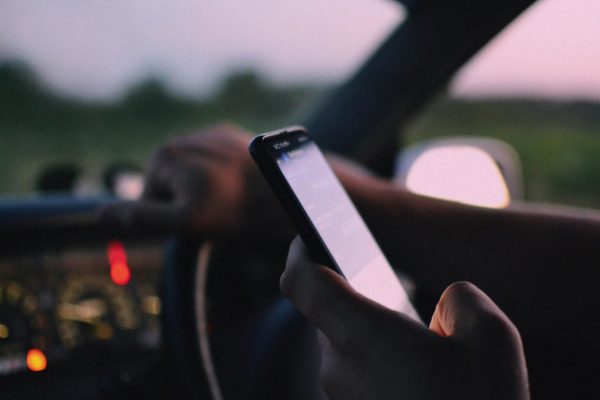 https://www.pexels.com/photo/a-person-inside-a-car-using-a-cellphone-12729860/